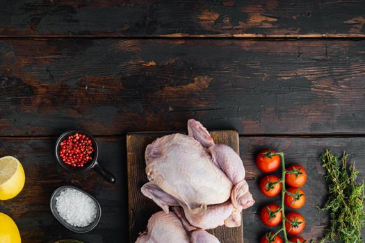 Fresh raw chicken meat with ingredients, on old wooden table, top view with copy space for text
