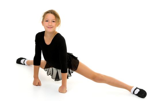 A sweet little gymnast girl performs an acrobatic element on the floor. The concept of sport, healthy lifestyle. Isolated on white background.