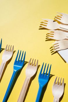 Flat lay photo comparison between disposable foam food container and plastic cutlery and reusable forks