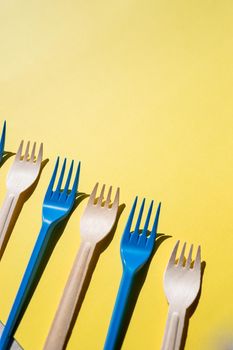 Flat lay photo comparison between disposable foam food container and plastic cutlery and reusable forks