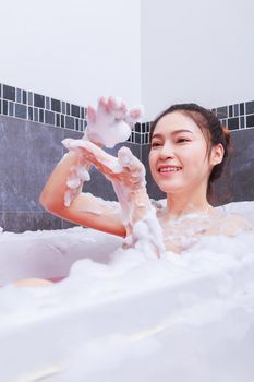 pretty woman relaxing in the bathtub in the bathroom