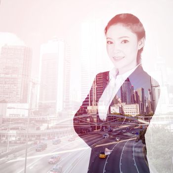 double exposure of  business woman crossed arms with Hong Kong city background