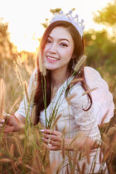 beautiful angel woman in a grass field with sunlight