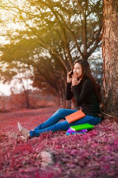 cheerful woman talking on mobile phone in the park