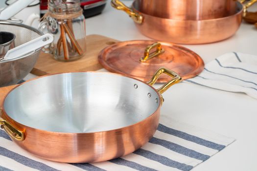 Clean cookware, utensils close up on table in modern kitchen. High quality photo