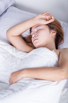 Woman sleeping on bed in the bedroom 