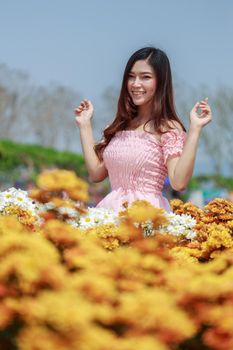 beautiful woman in colorful chrysanthemum glower garden 