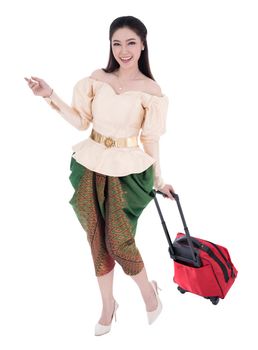 happy woman in Thai traditional dress walking & dragging suitcases isolated on white background