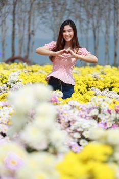 beautiful woman in colorful chrysanthemum glower garden 