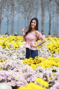 beautiful woman in colorful chrysanthemum glower garden 