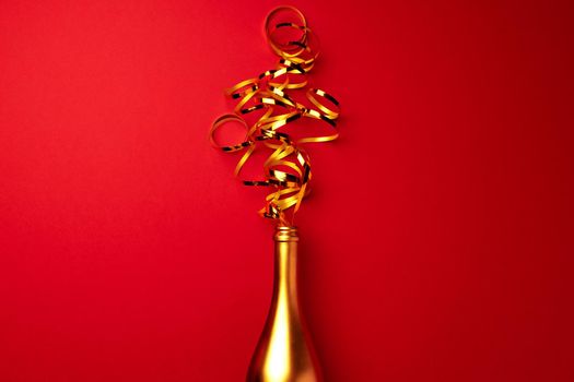 Champagne bottle with streamers flat lay top view, Christmas background