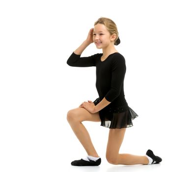 A gymnast girl prepares for the exercise. The concept of childhood and sport, a healthy lifestyle. Isolated on white background.