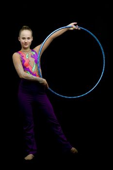 A girl gymnast performs an exercise with a hoop. The concept of gymnastics and fitness. Isolated.