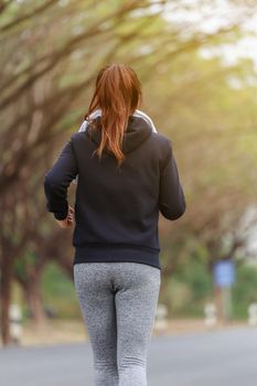 young fitness woman running in the park