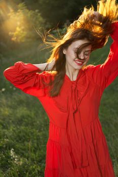 woman in red dress posing nature sun fun. High quality photo