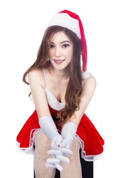beautiful sexy girl wearing santa claus clothes and sitting isolated on white background