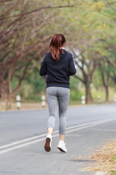 young fitness woman running in the park