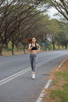 beautiful fitness woman running in the park