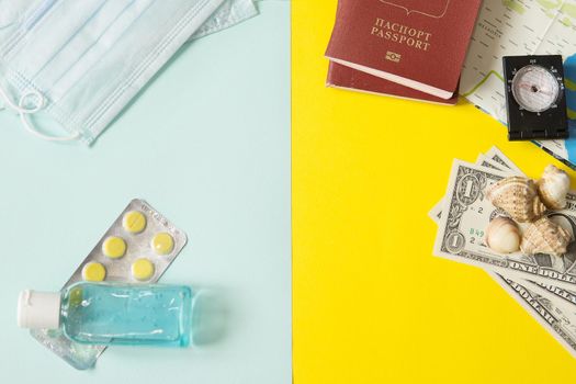 Travel concept with tablets, sterile mask, antiseptic and road symbols id passport, money, compass, map. Stop traveling to dangerous places to prevent coronavirus. Space for text