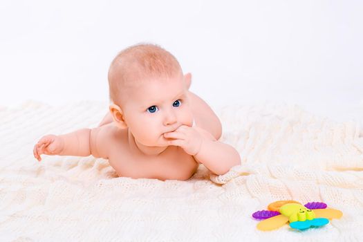 Cute baby girl on white background. Baby in diaper with toy