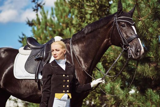 woman jockey with his horse in uniform for Dressage