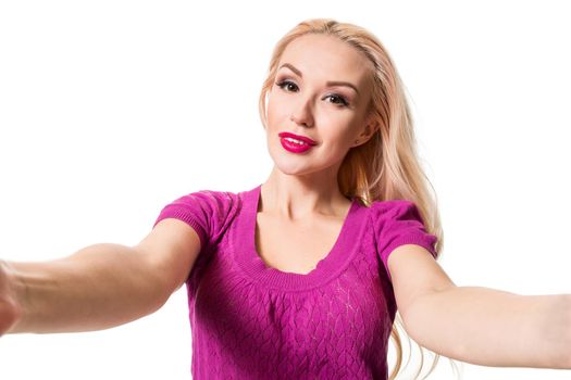 Smiling cheerful blond-haired woman doing selfie on isolated white background. Taking picture.