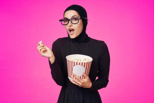 Muslim woman attractive look popcorn glasses movie watching isolated background. High quality photo