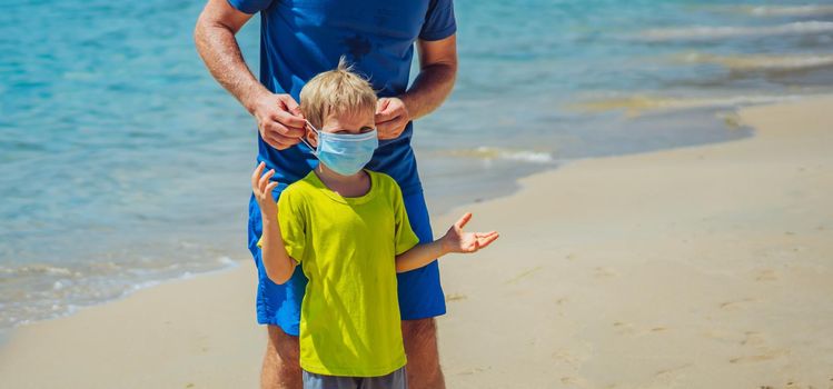 Normal reality COVID pandemic. Father ask boy put on mask protect coronavirus, son refuses does not want to constantly wear it everywhere, get tired of mask, walk nature sea beach forest park sun day.