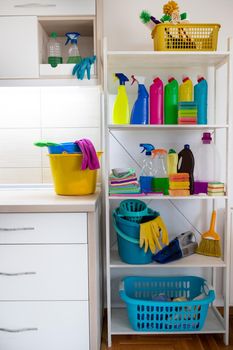 Cleaning supplies and tools on shelves and cabinets in pantry room