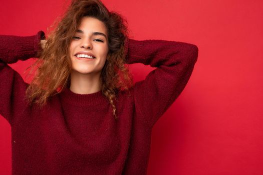 Photo of beautiful positive smiling adult woman wearing stylish clothes standing isolated on colorful background with copy space looking at camera.