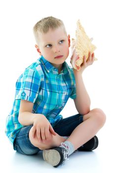 A cute little boy with a sea shell. The concept of a family vacation at sea, advertising of summer tourism. Isolated on white background.