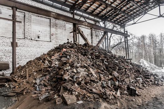 A bunch of old dirty rusty metal and iron waste to recycle in a landfill steel trash.