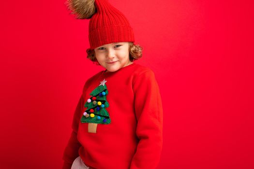 emotional portrait of a teenager on a red background in a new year costume.