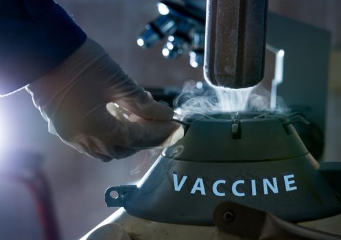 Doctor with safety gloves opening liquid nitrogen  container for vaccin keeping