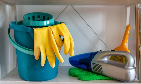 Cleaning tools on shelf in pantry room. Housekeeping concept