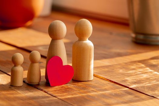 Small wooden figures of family members close up. Family relationship symbol
