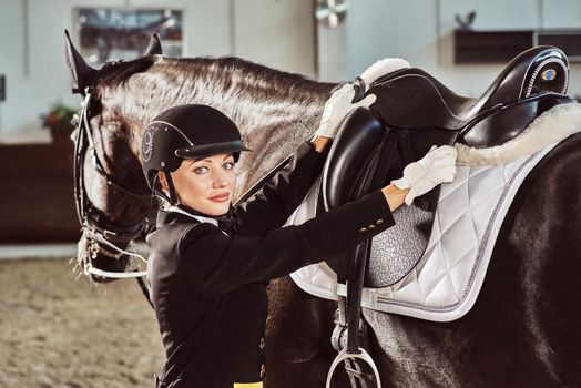woman jockey with his horse in uniform for Dressage. close up