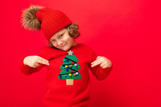 emotional portrait of a teenager on a red background in a new year costume.