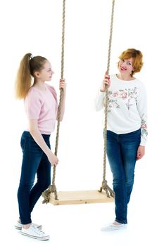 Happy mom and daughter swing on a swing. The concept of family happiness, parenting. Isolated on white background.