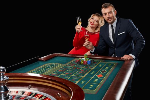 Couple playing roulette wins at the casino. Addiction to the gambling. celebrating the victory and win