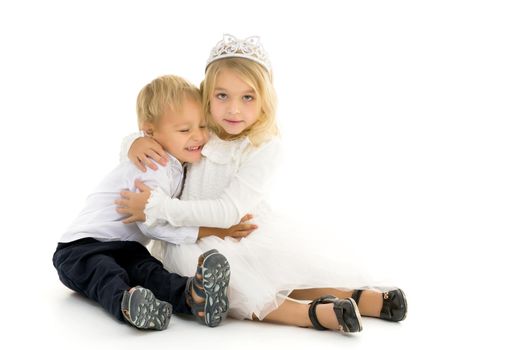 Boy and girl, brother and sister posing in the studio. Concept of family values, friendship, game. Isolated on white background