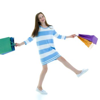 A little girl is jumping and waving her hands. The concept of a happy childhood, outdoor recreation. Isolated on white background.