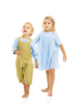 Boy and girl, brother and sister posing in the studio. Concept of family values, friendship, game. Isolated on white background