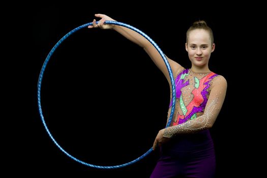 A girl gymnast performs an exercise with a hoop. The concept of gymnastics and fitness. Isolated.