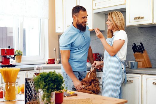 Couple in love preparing meal together in kitchen at home