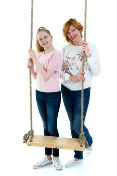 Happy mom and daughter swing on a swing. The concept of family happiness, parenting. Isolated on white background.