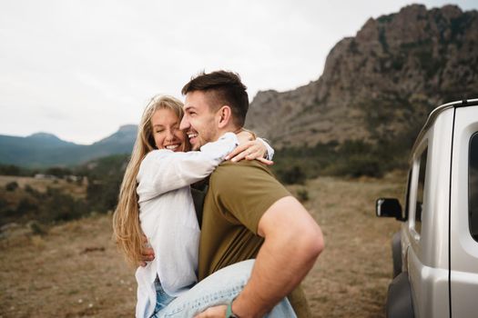 Young couple is on romantic trip to the mountains by car, close up