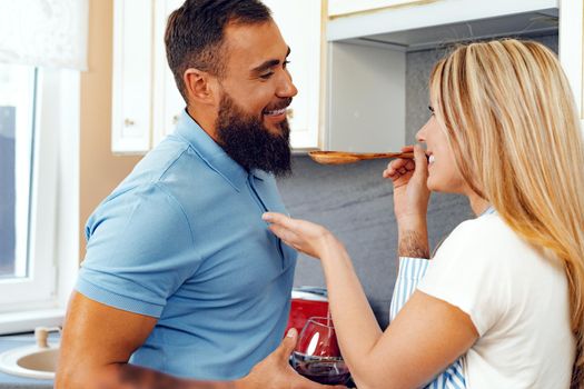 Couple in love preparing meal together in kitchen at home