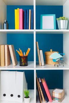 Stacks of supplies and paperwork in the office and bookshelves