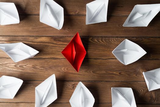 Set of origami boats on wooden table